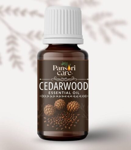 Pansari Care Cedarwood Essential Oil bottle with cedarwood chips and a piece of cedarwood.